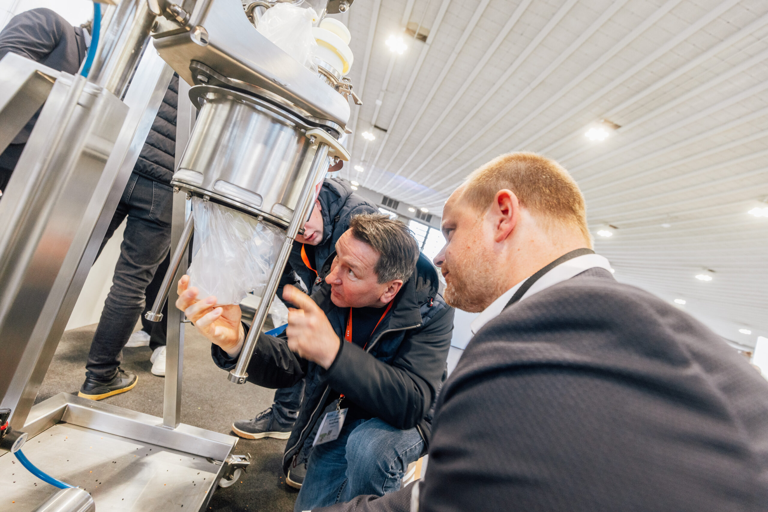 Trade fair visitors inspecting industrial equipment at SOLIDS & RECYCLING-TECHNIK Dortmund
