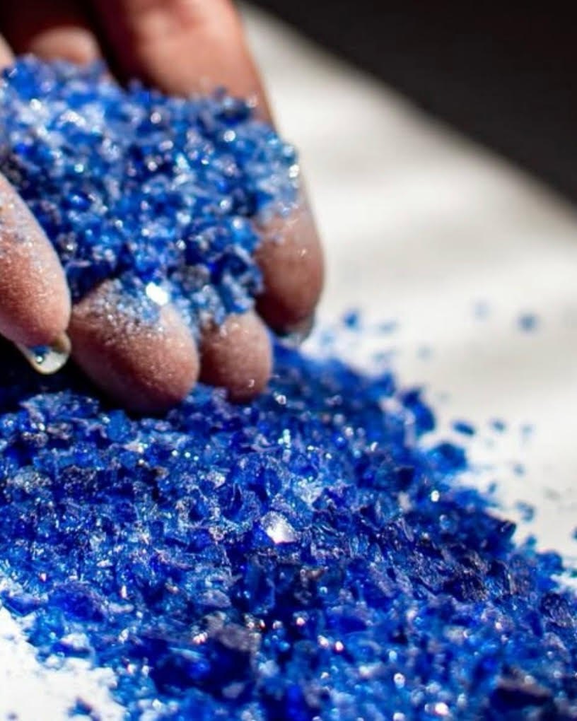 Close-up of processed blue glass cullet that looks almost like gems