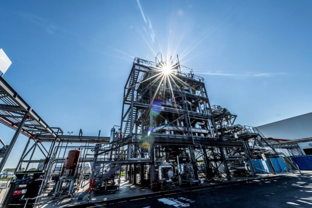 Chemical recycling plant in Ostend with steel structures against a sunny blue sky