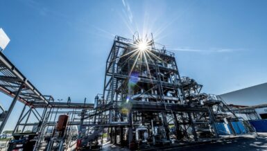 Chemical recycling plant in Ostend with steel structures against a sunny blue sky
