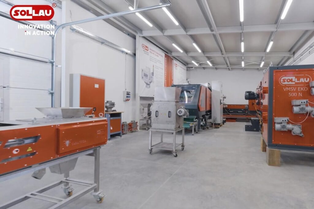 Metal separation test hall with orange magnetic separators and test rigs on a grey floor