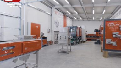Metal separation test hall with orange magnetic separators and test rigs on a grey floor