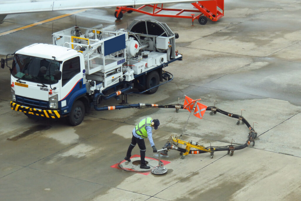 Fuel truck refuelling a passenger aircraft on the apron