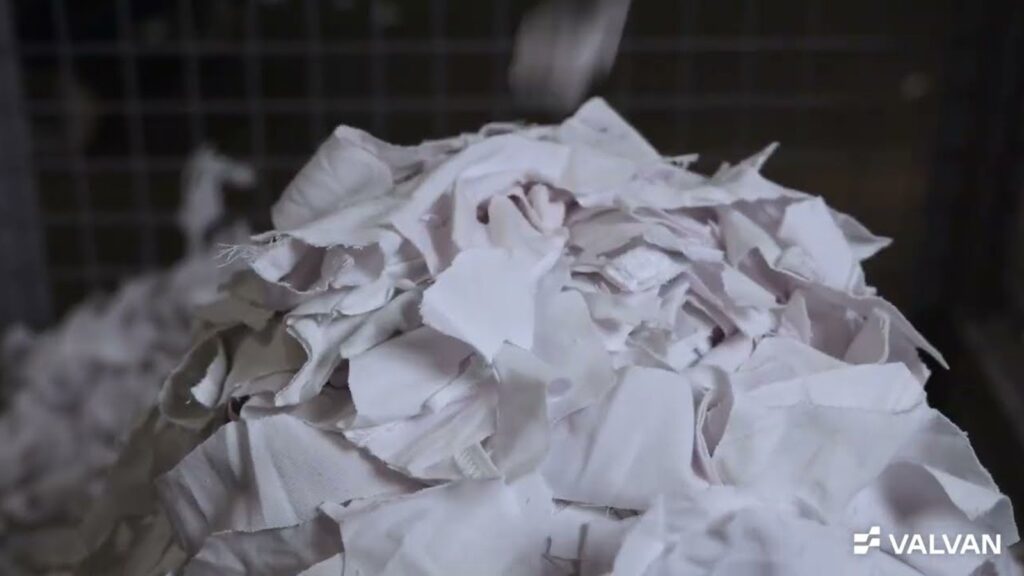 Pile of white pre-cut textile clippings inside the Valvan Trimclean trim removal system