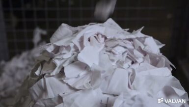 Pile of white pre-cut textile clippings inside the Valvan Trimclean trim removal system